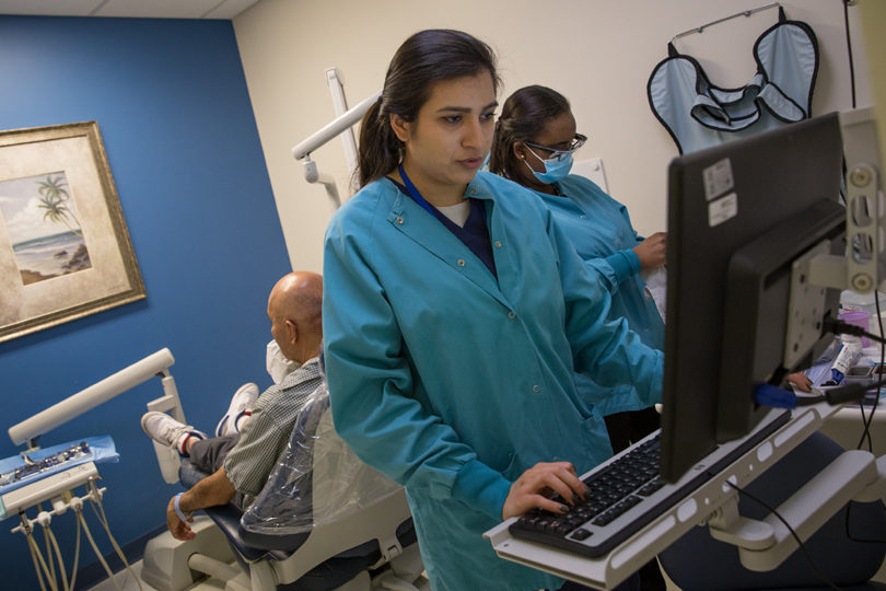 Medical technician at computer